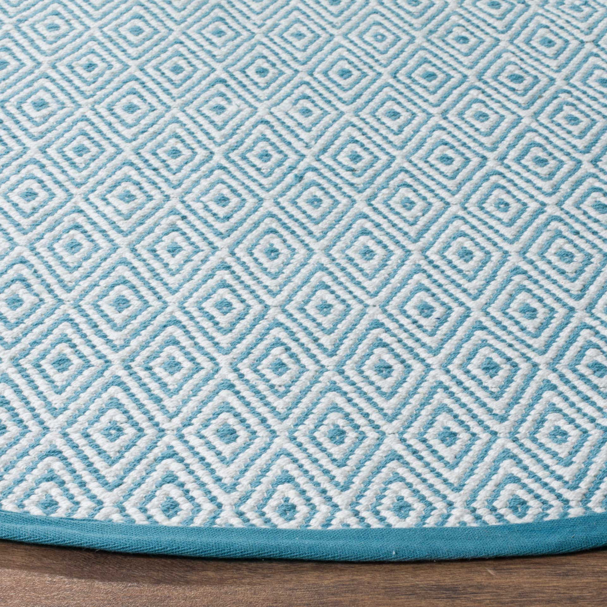 Light blue and ivory diamond weave meets a neatly finished blue edge.