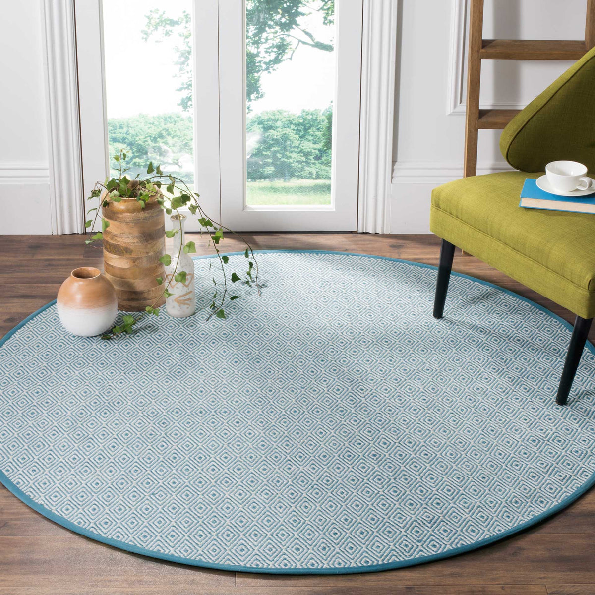 Light blue and ivory geometric rug adds a fresh touch beneath a lounge chair.