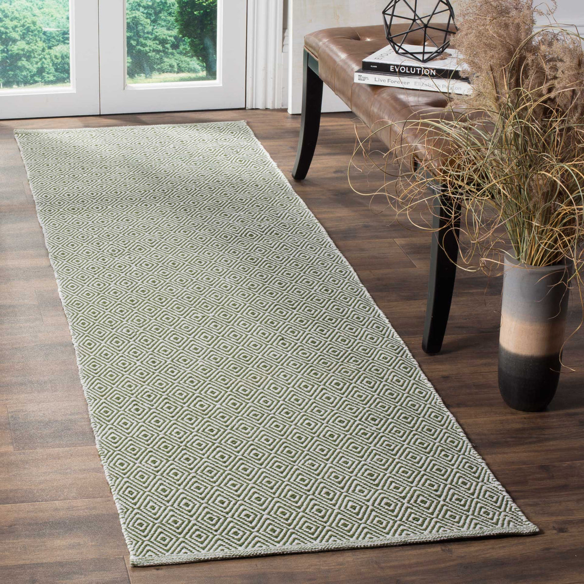 Muted green diamonds add grounded color and texture to this ivory runner