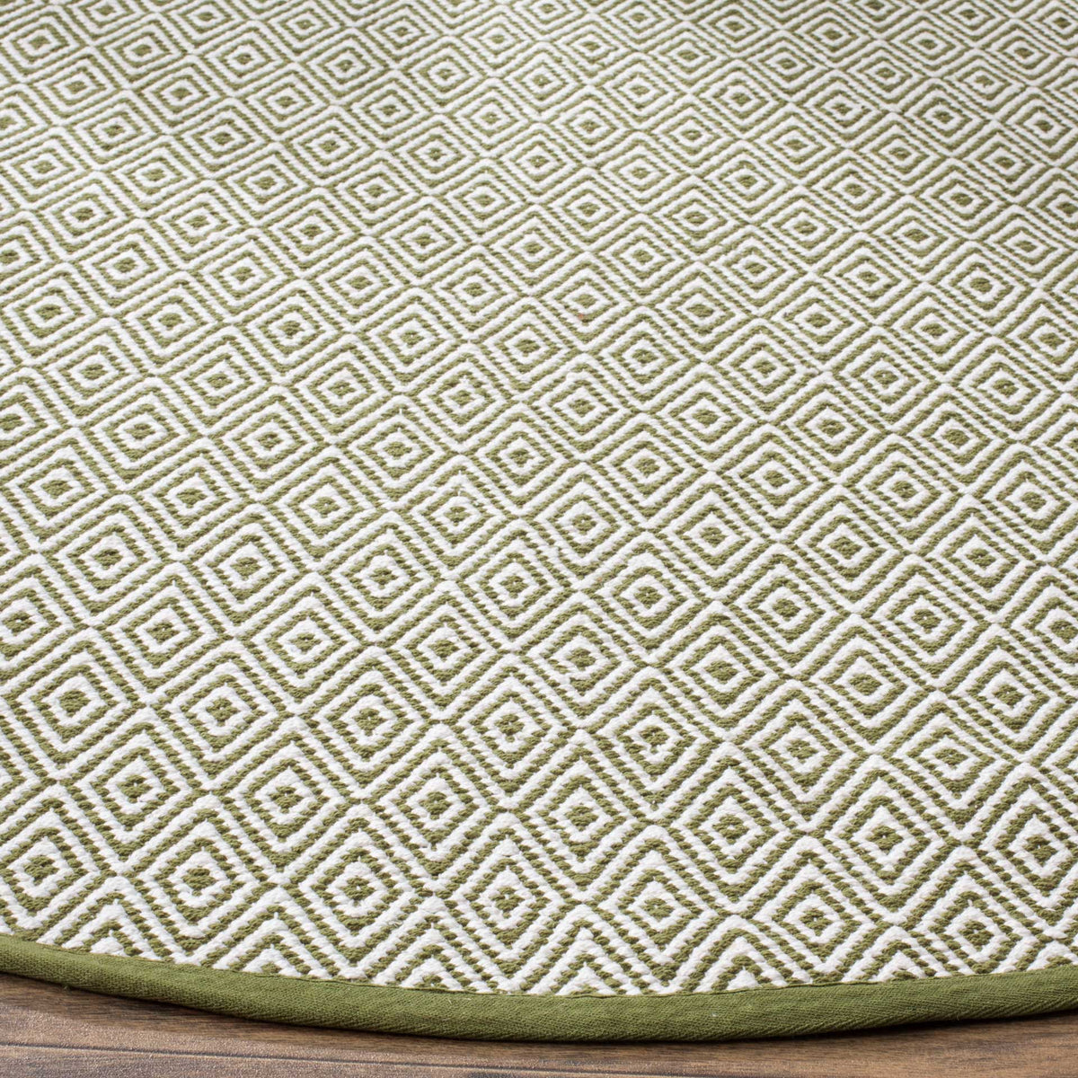 Olive green and ivory diamonds reveal a textured weave and a clean, bound edge.