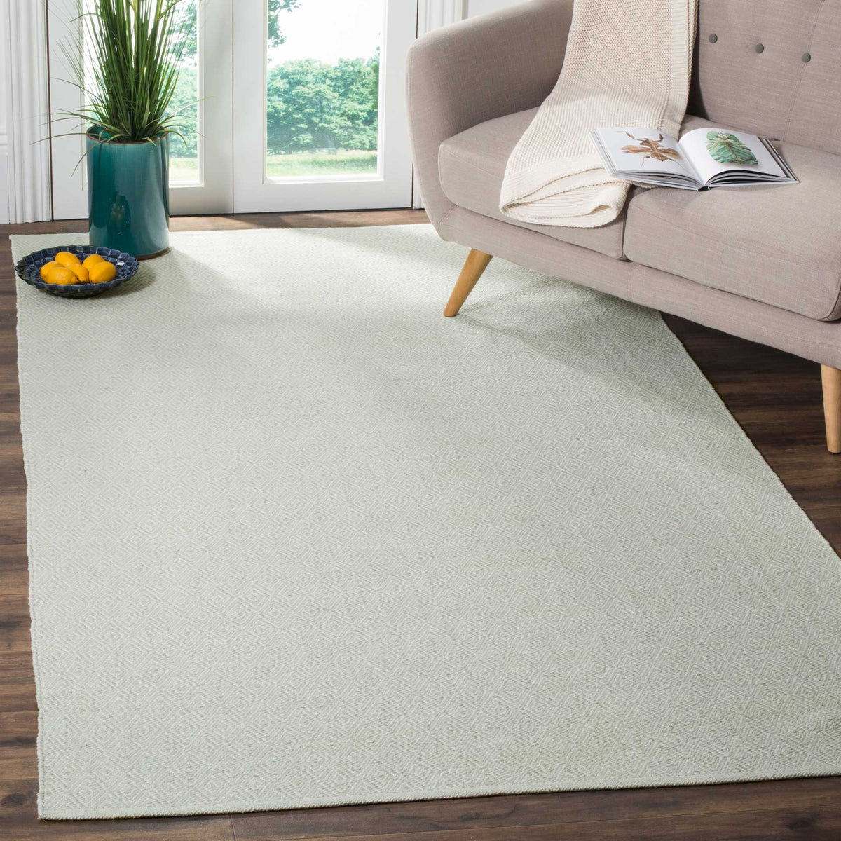 Subtle foam green diamonds bring a calm finish beneath living room seating