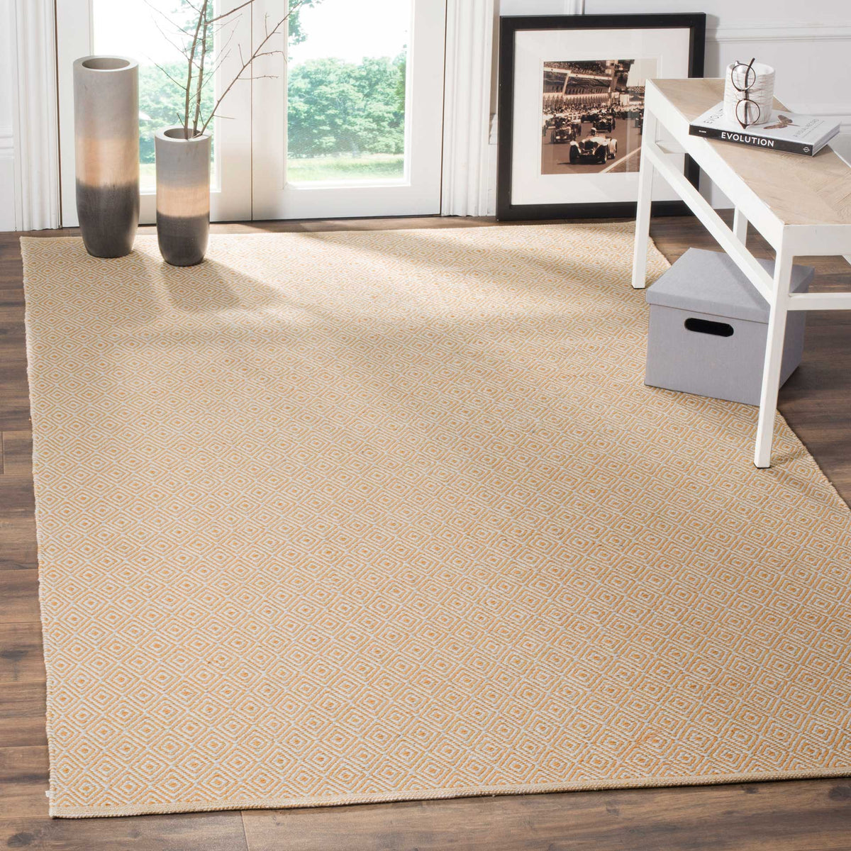 Warm gold and ivory diamonds brighten a living area beneath a white coffee table