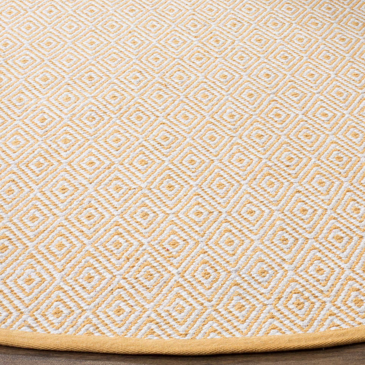 Textured ivory diamonds cross a warm gold ground above a neatly finished edge.