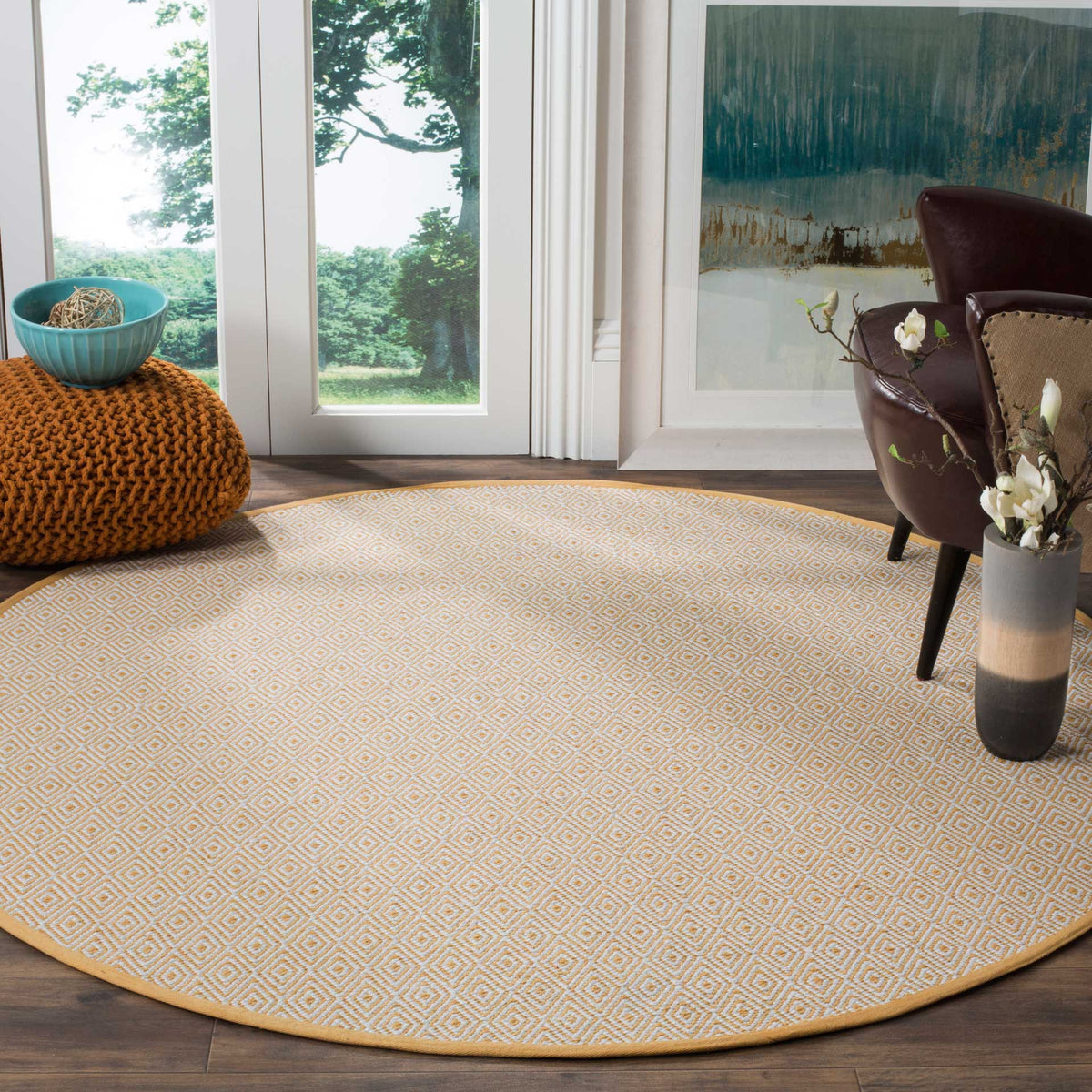 Ivory and gold geometric rug brings inviting warmth to a sitting area.