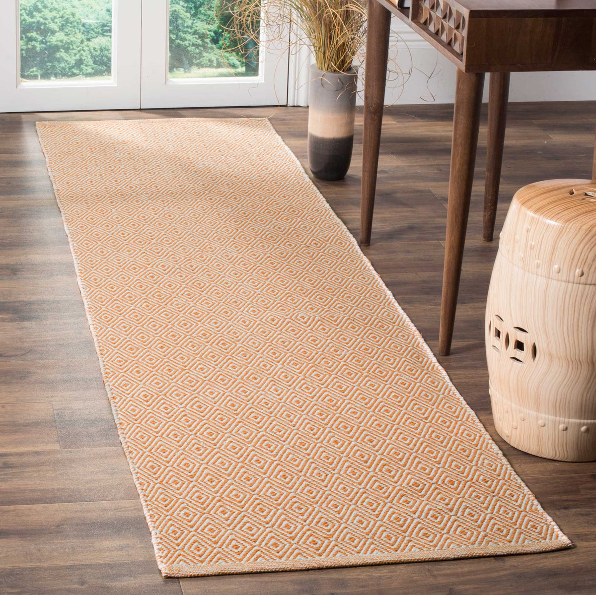 Warm rust diamonds brighten this ivory runner with vibrant geometric detail