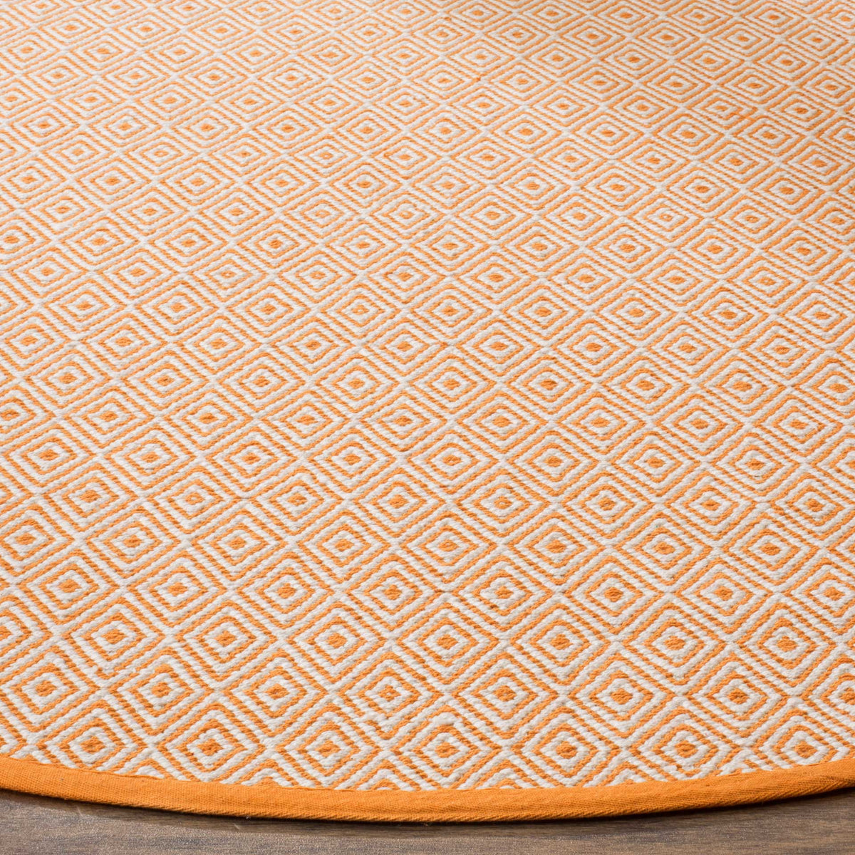 Rust and ivory woven diamonds form a lively pattern above a neatly bound edge.