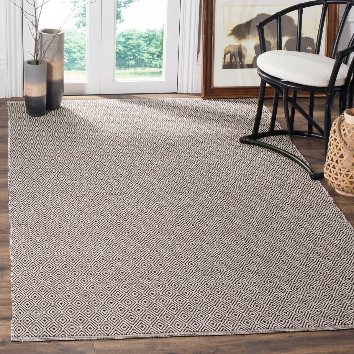 An ivory and chocolate diamond rug lends warm contrast beneath a lounge chair