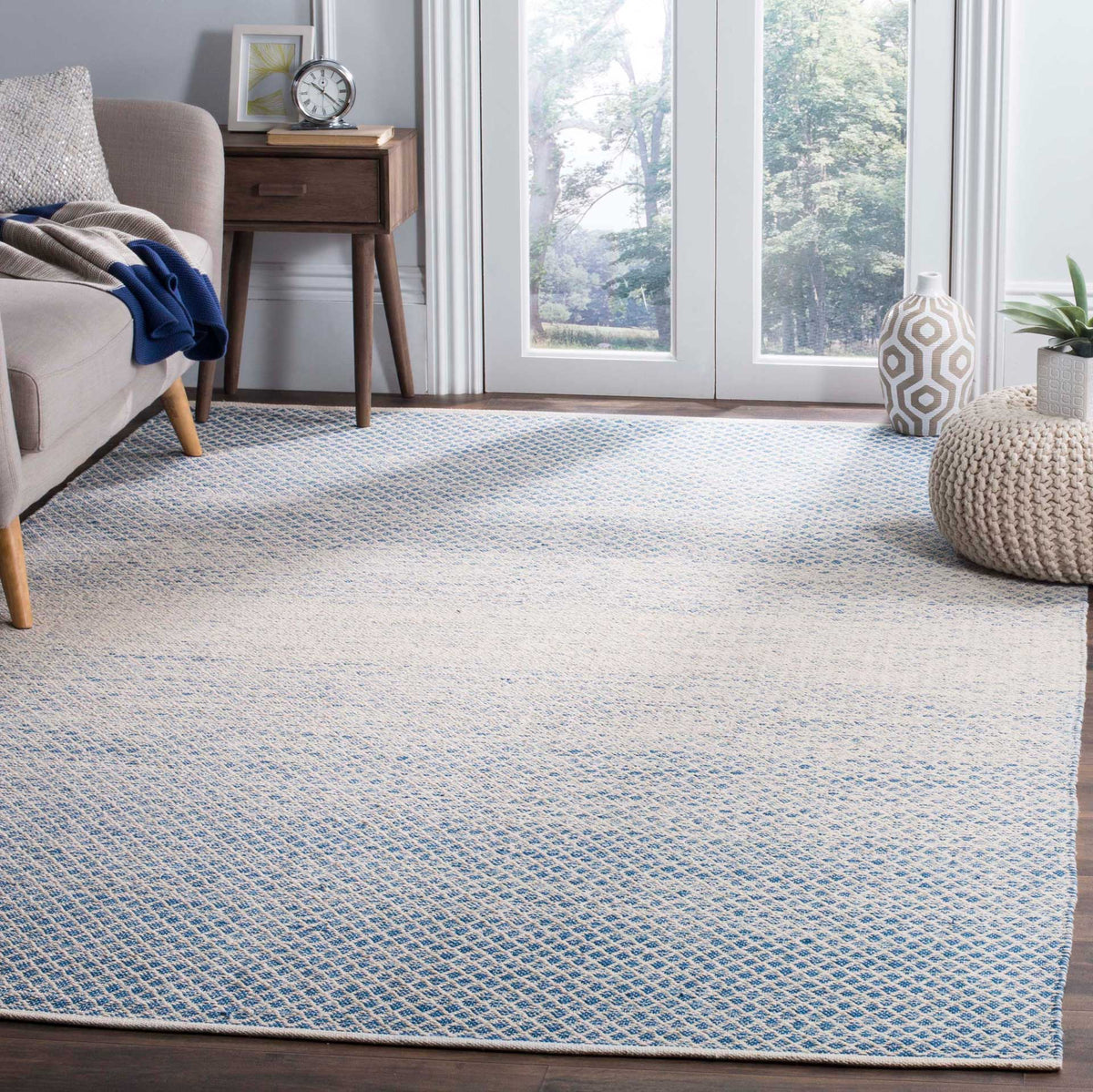 Blue woven diamonds fade into an ivory center, adding relaxed color to the floor.