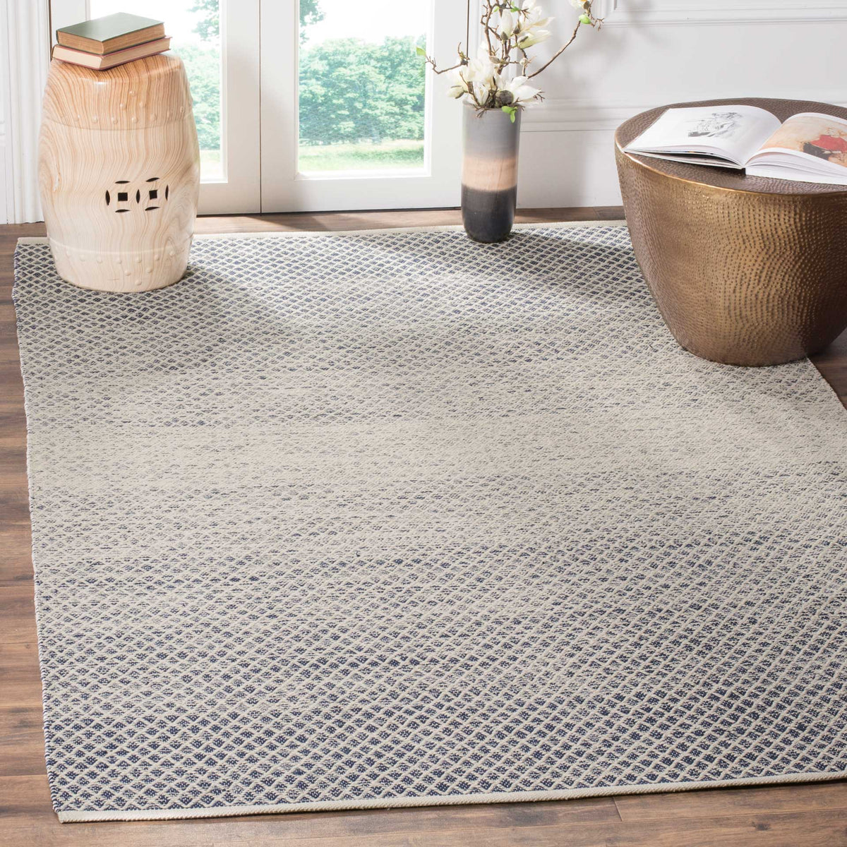 Navy and ivory diamonds bring crisp woven texture beneath warm wood accents.