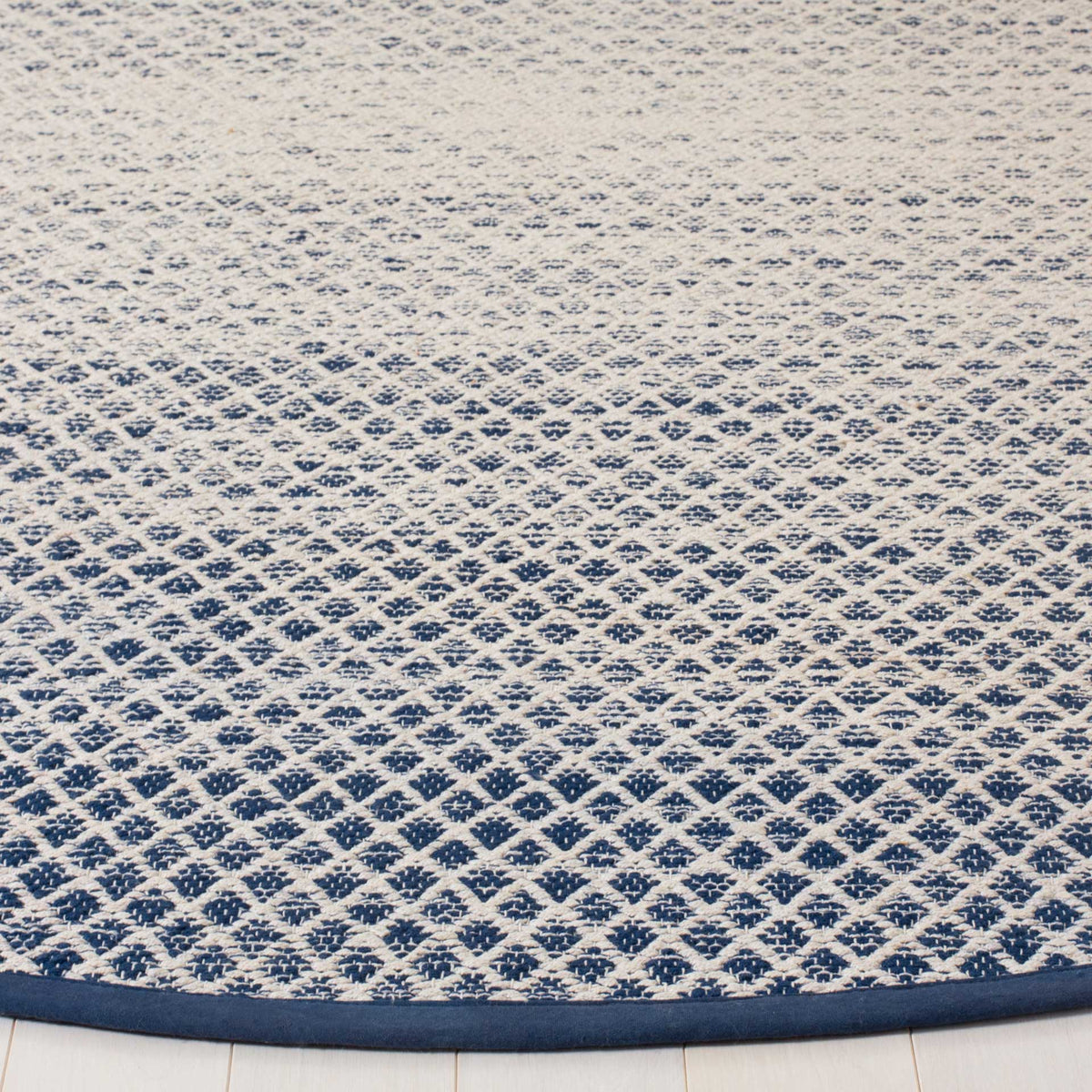 Intricate navy diamonds scatter across ivory cotton, finished with a smooth navy border