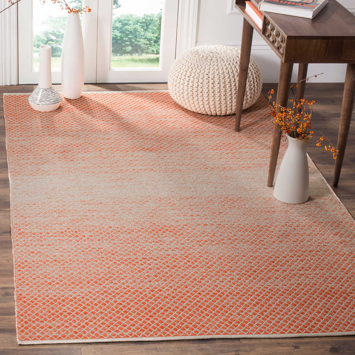 Orange and ivory latticework lends lively warmth, with a pale center to soften the design.