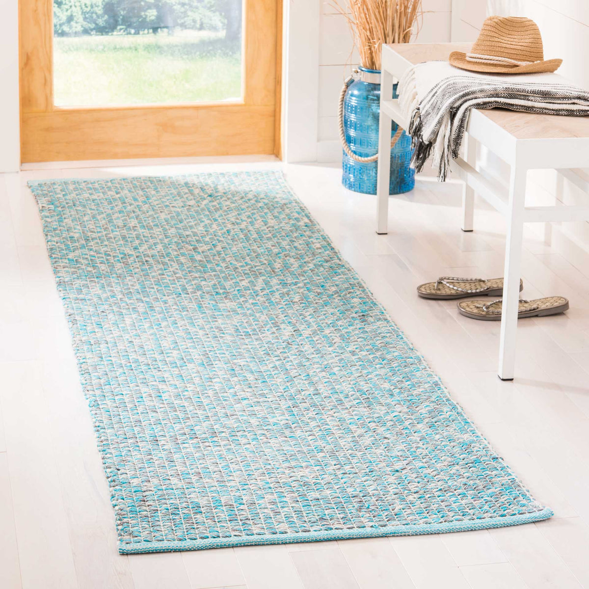 Turquoise woven runner brings fresh color and softly flecked texture to an entryway