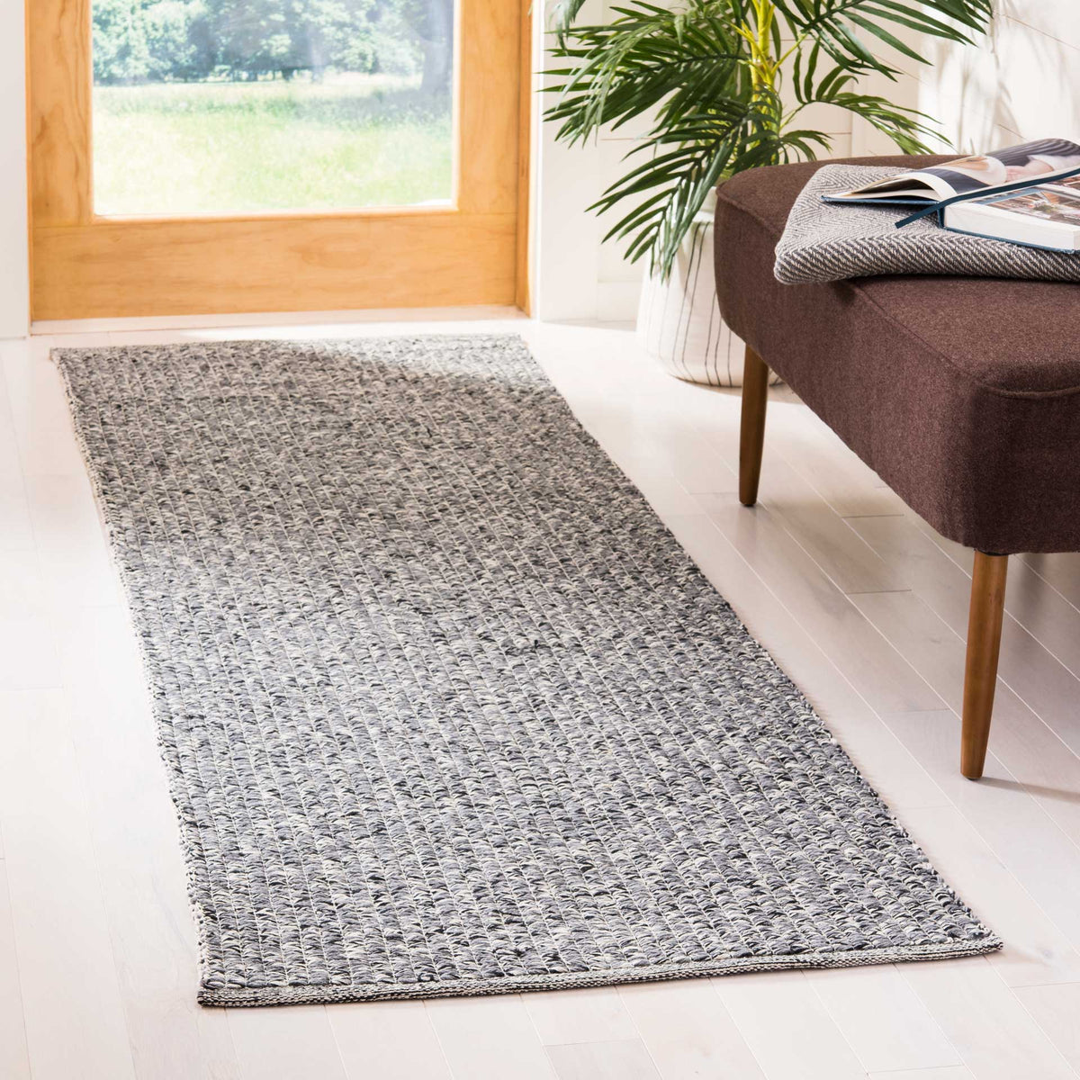 Gray-and-ivory woven runner adds understated texture to a bright entryway