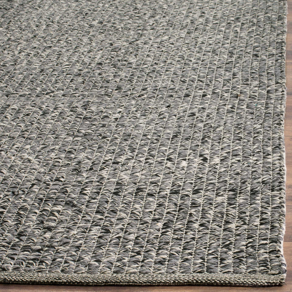 Textured gray cotton weave ends in a neatly finished rug corner