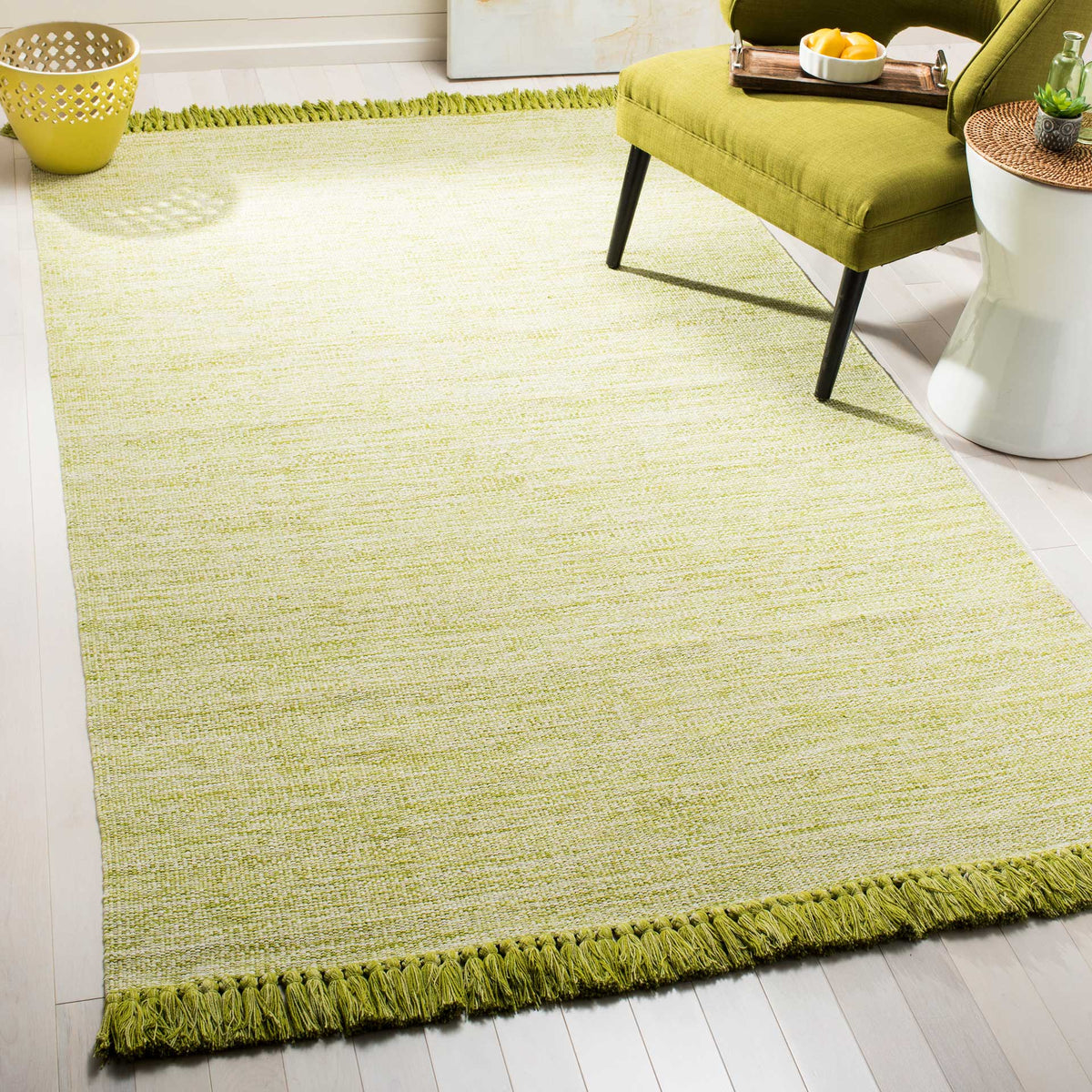 Soft olive-green tones and tasseled ends bring a fresh, natural accent beneath furniture.