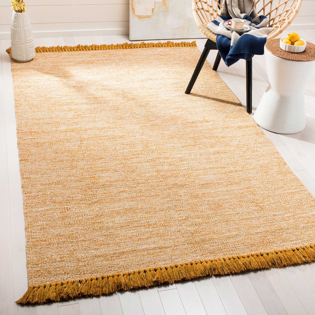 Golden fringe and softly blended tones add a sunny foundation beneath furniture.
