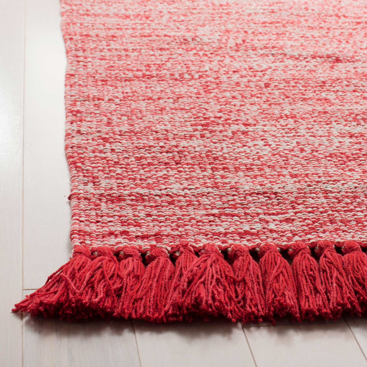 Bold red fringe finishes a nubby red-and-ivory cotton weave for a cheerful touch.