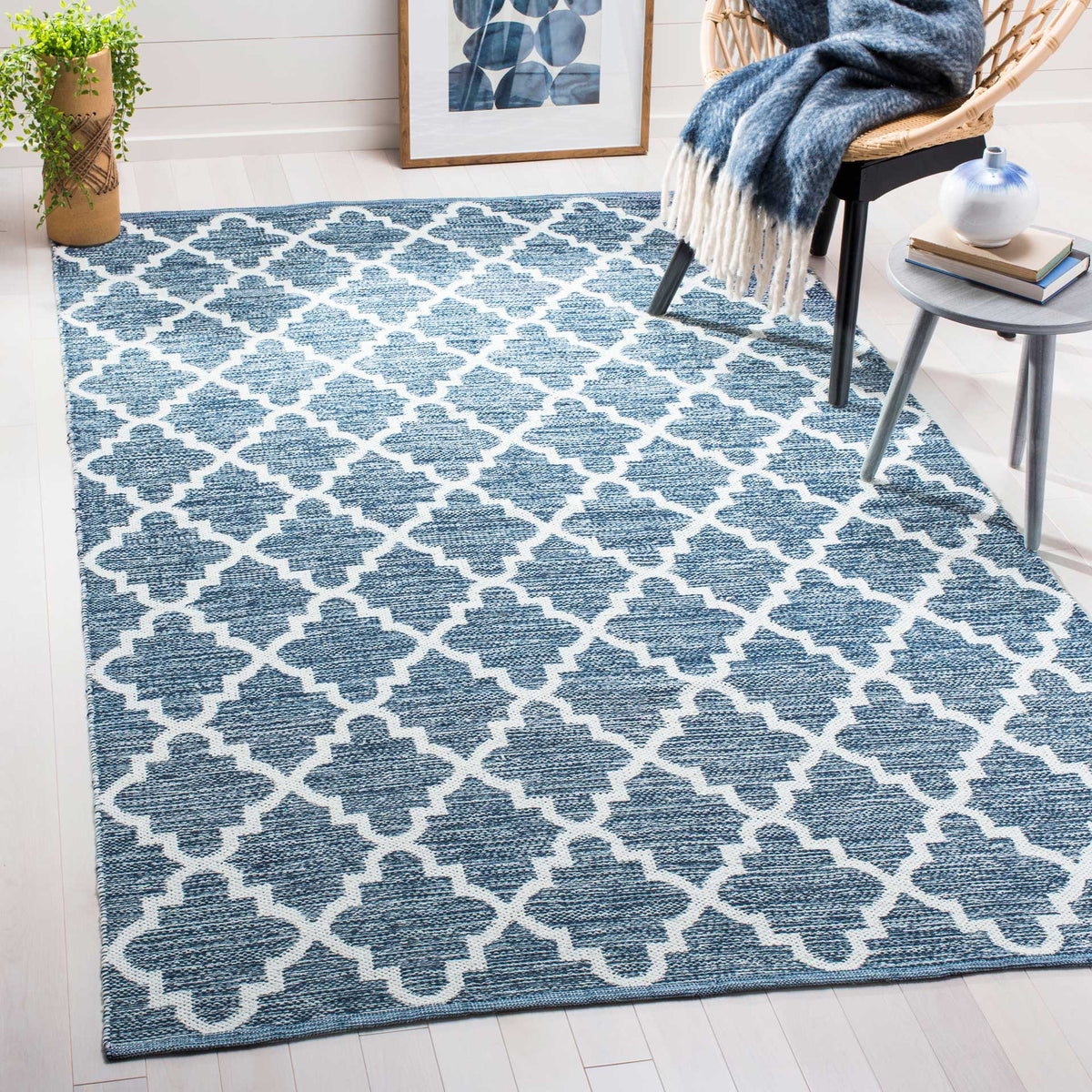 A navy and ivory trellis rug brings rich contrast to a bright seating area.