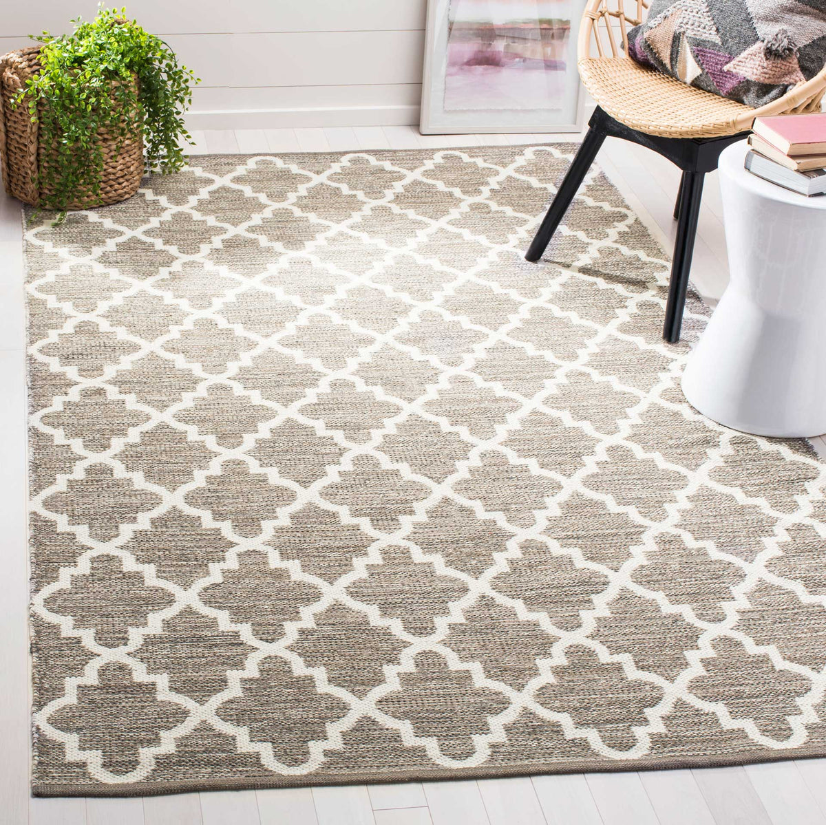 An airy beige and ivory trellis rug adds soft pattern beneath accent furniture.