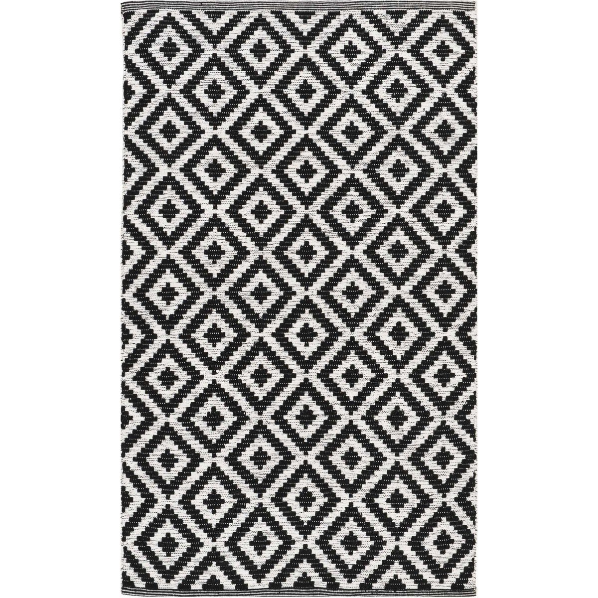 Large black diamonds bring graphic energy to a compact ivory cotton rug.