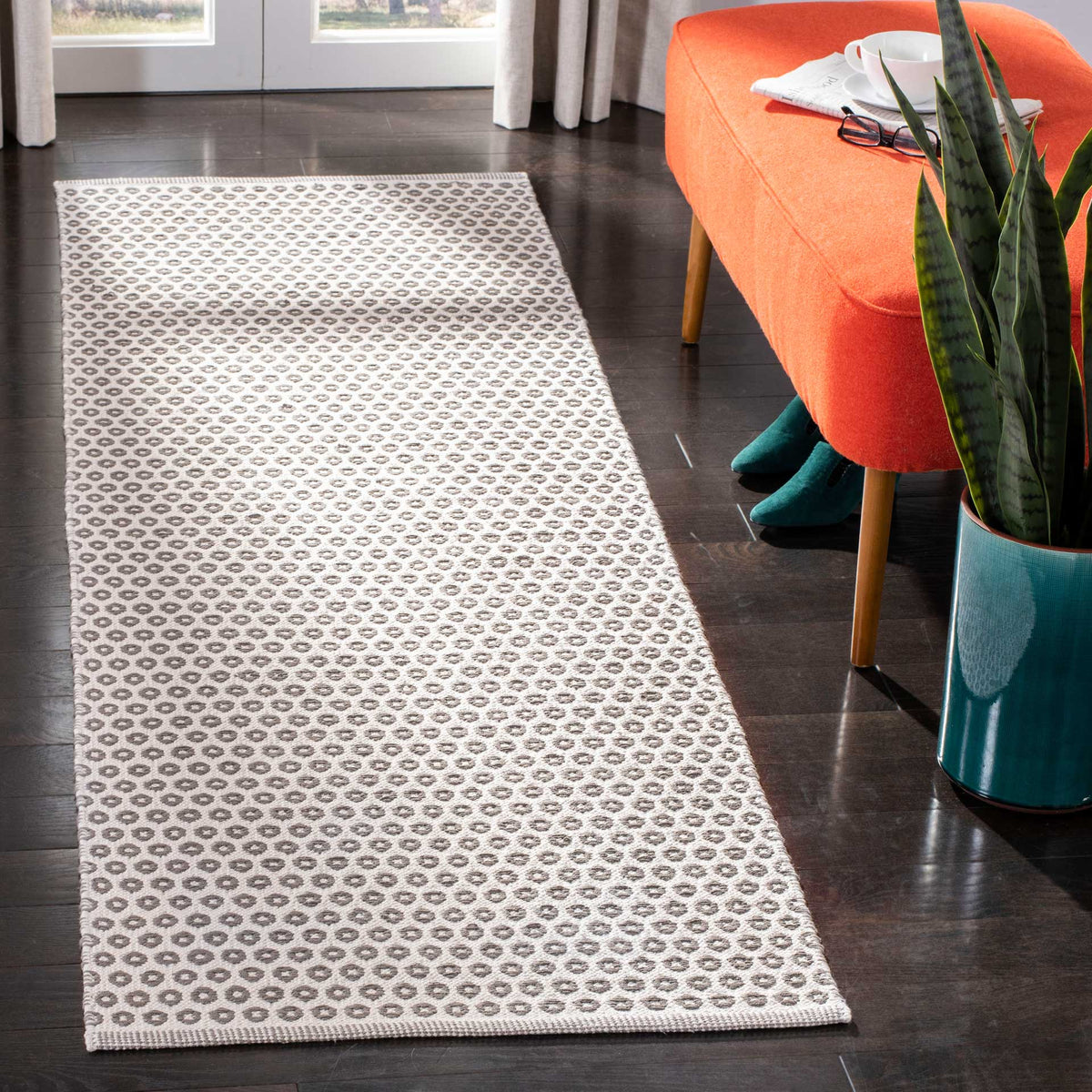 A slim gray and ivory runner brings soft texture and geometric detail to a modern space.