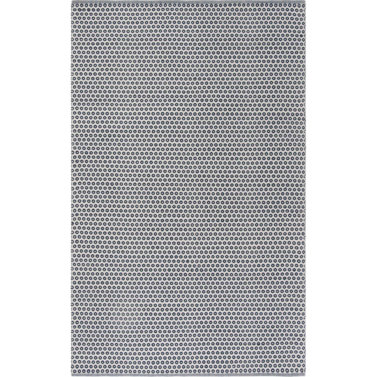 Rows of navy ring motifs give this handwoven ivory cotton rug a striking graphic rhythm