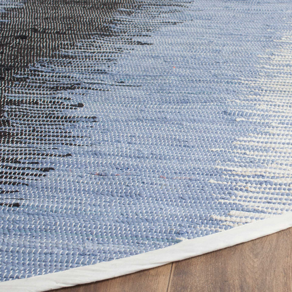Woven blue and black cotton meets a clean, pale bound edge