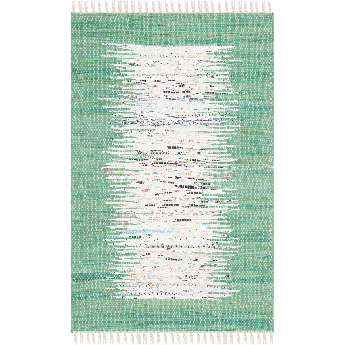 A petite ivory and sea green rug brightens the floor with a flecked center and handmade fringe.