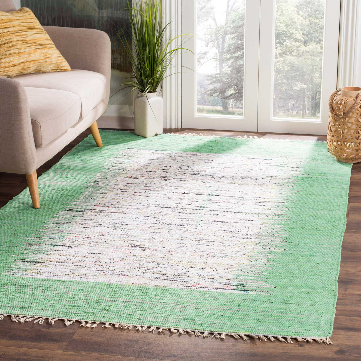 A sea green and ivory rug lends airy color and nubby cotton texture to a relaxed living space.