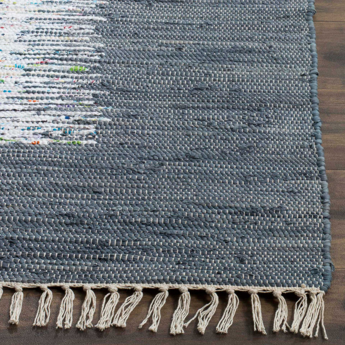 Cream fringe and a close-knit gray cotton weave lend a handcrafted feel to this rug's edge.