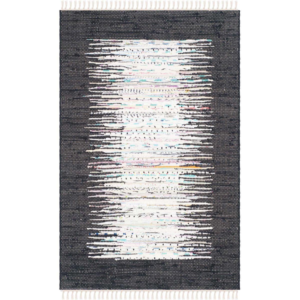 A compact ivory and black rug combines handwoven texture, a painterly center, and ivory fringe.