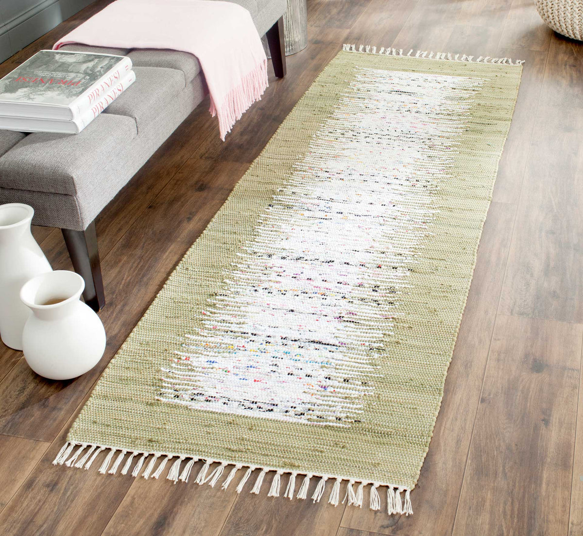 The soft olive border gives the ivory abstract runner a natural accent on warm wood floors.