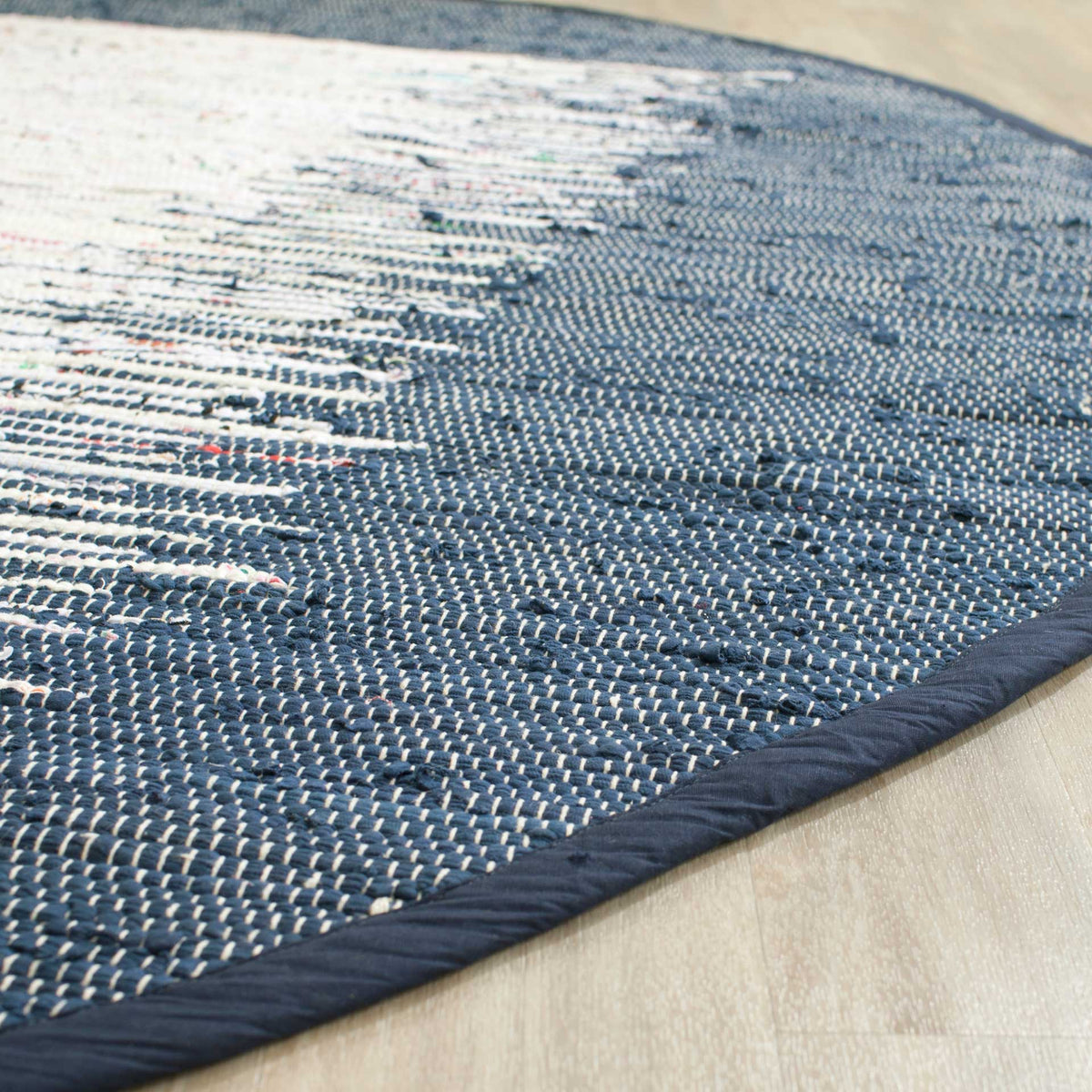 Navy binding and woven cotton loops add texture beside the contrasting ivory pattern
