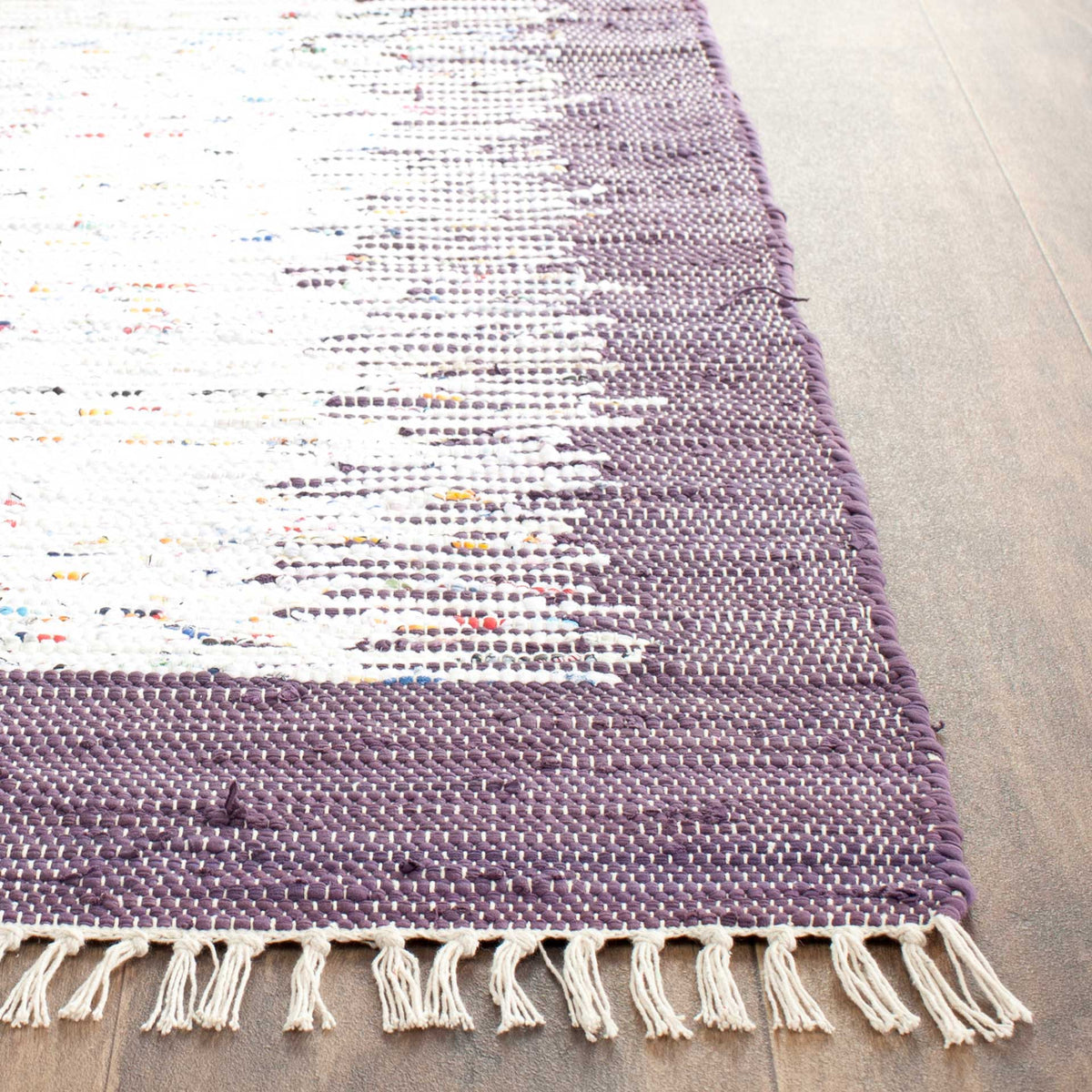 Purple and ivory cotton threads meet at a textured edge finished with loose ivory fringe.