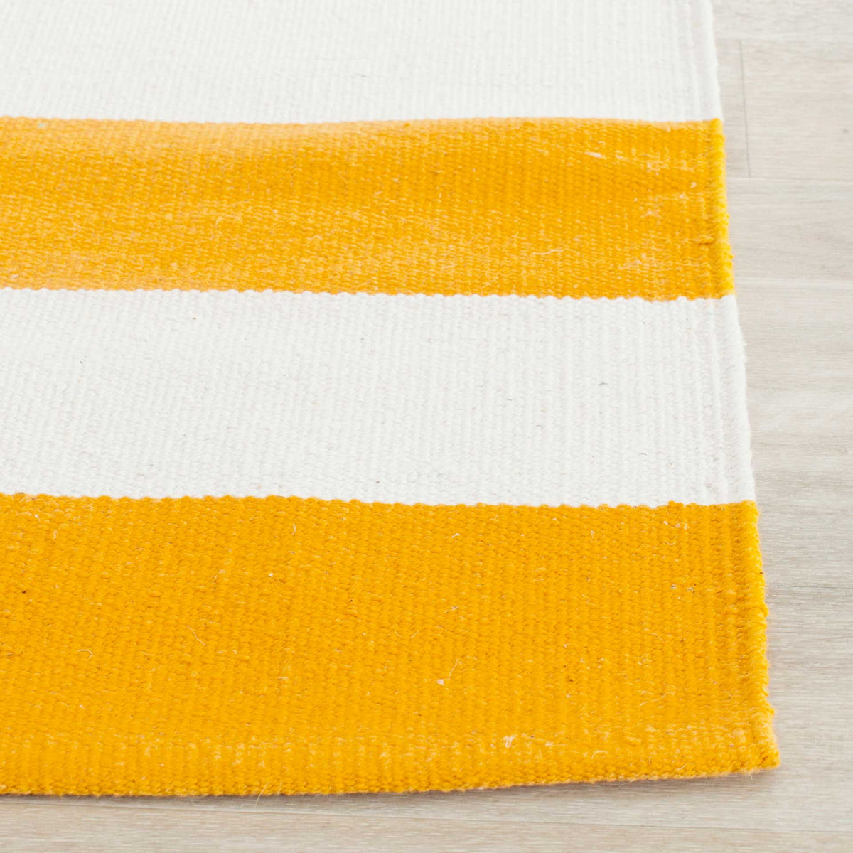 Golden yellow and ivory bands show the cotton's tactile weave and clean edge.