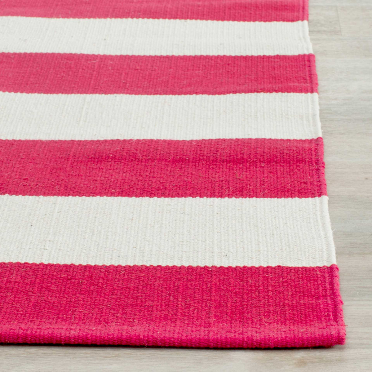 Rich red stripes and ivory bands show off a tactile weave and neatly finished edge.