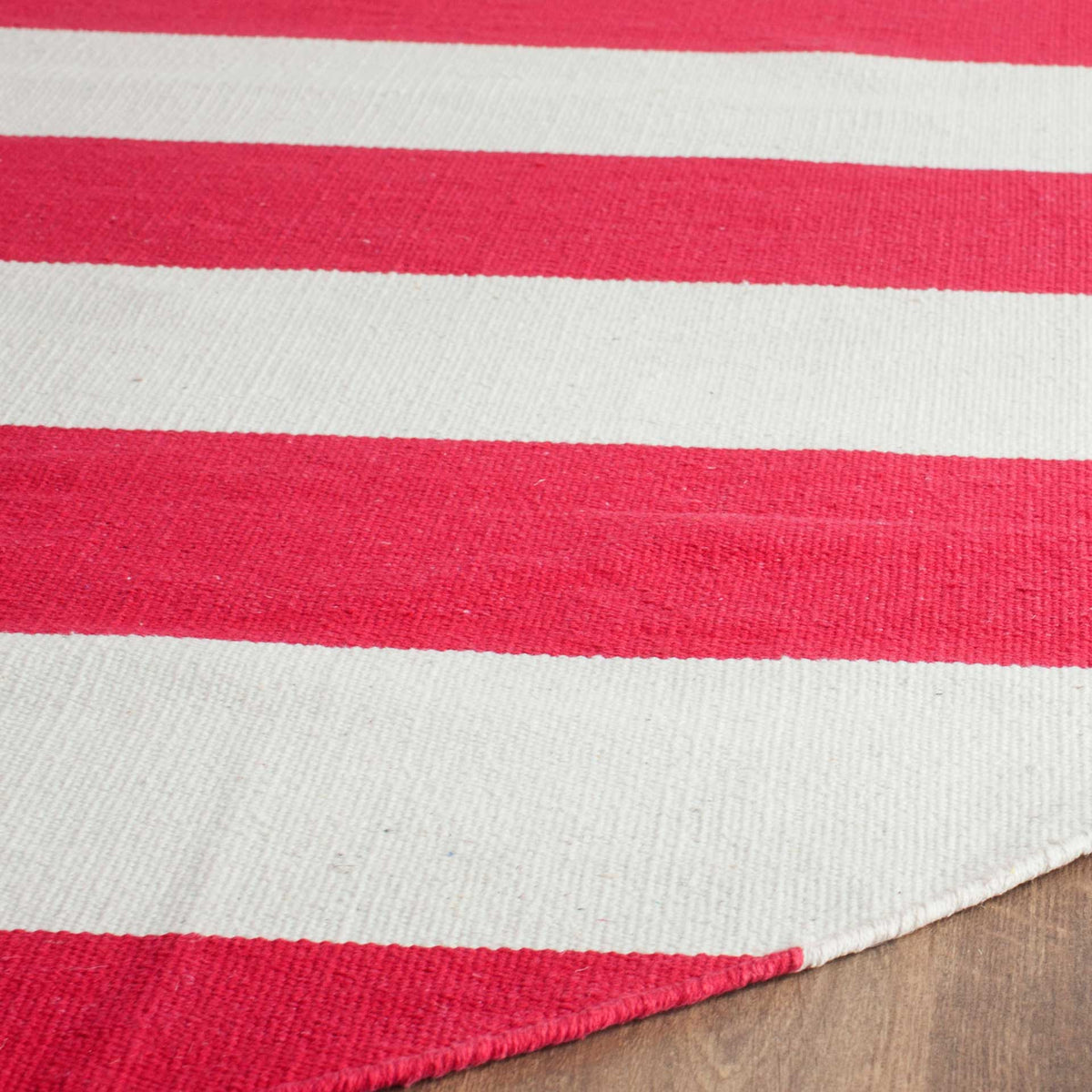 Woven red and ivory bands meet at a neatly finished edge for a crisp, textured look.
