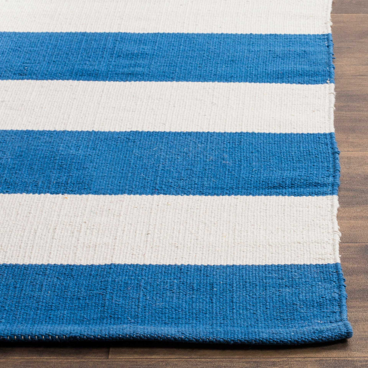 A neatly finished edge frames textured blue and ivory cotton stripes.
