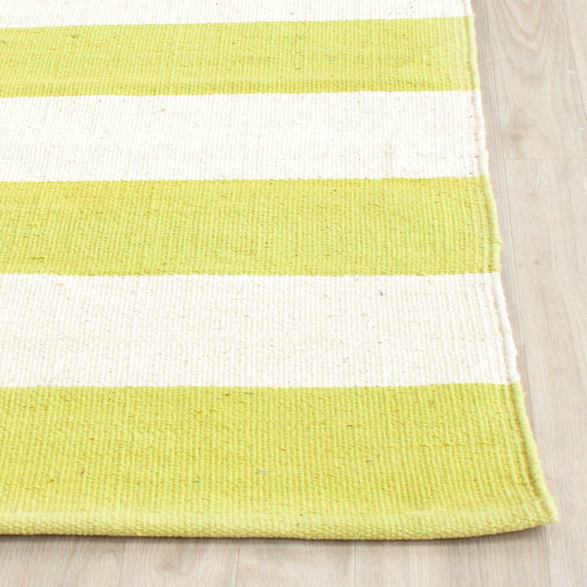 Woven cotton texture and a tailored edge accent soft yellow-green and ivory stripes.