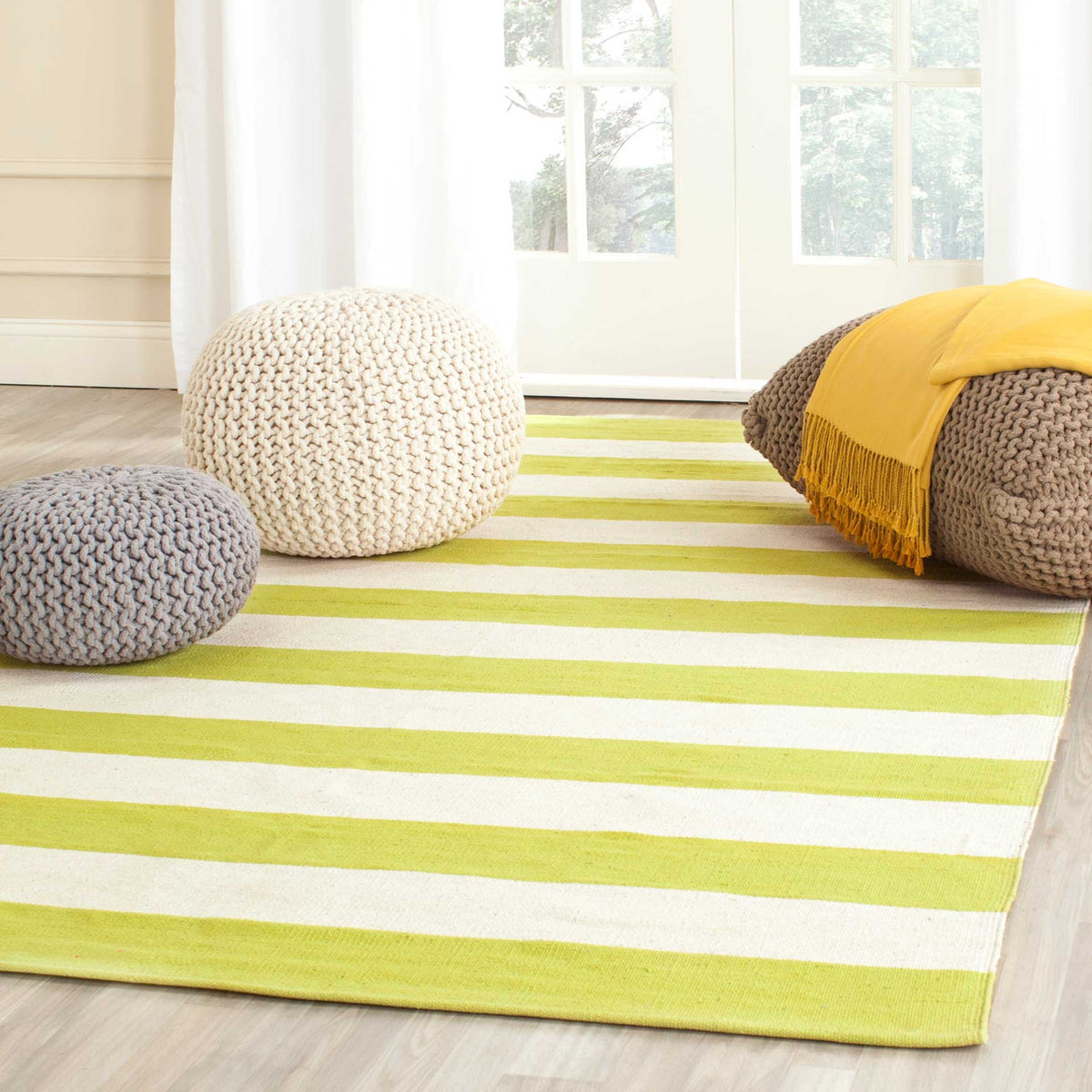 Zesty lime-green and ivory stripes enliven a cozy living area with fresh color.