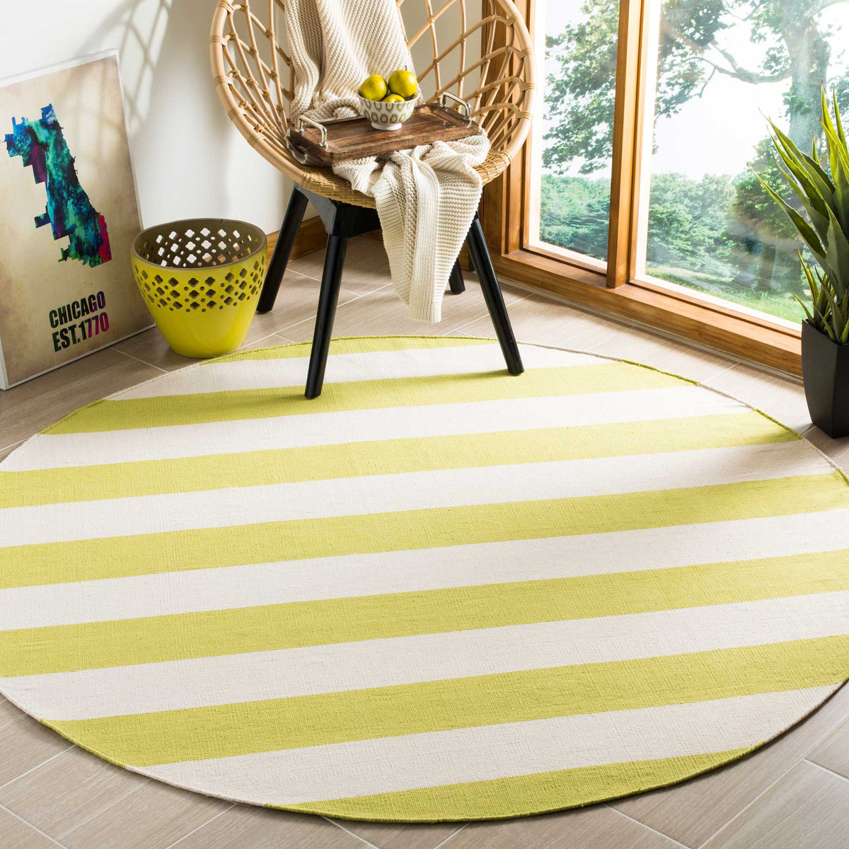Pale green and ivory bands bring a fresh accent to this round rug beneath a woven chair.