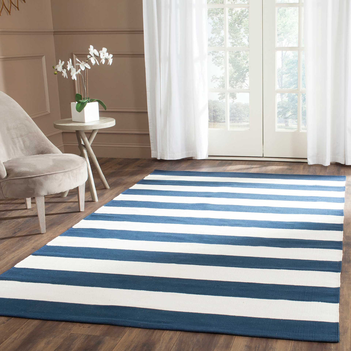 Classic navy and ivory stripes add crisp contrast to a softly furnished room.
