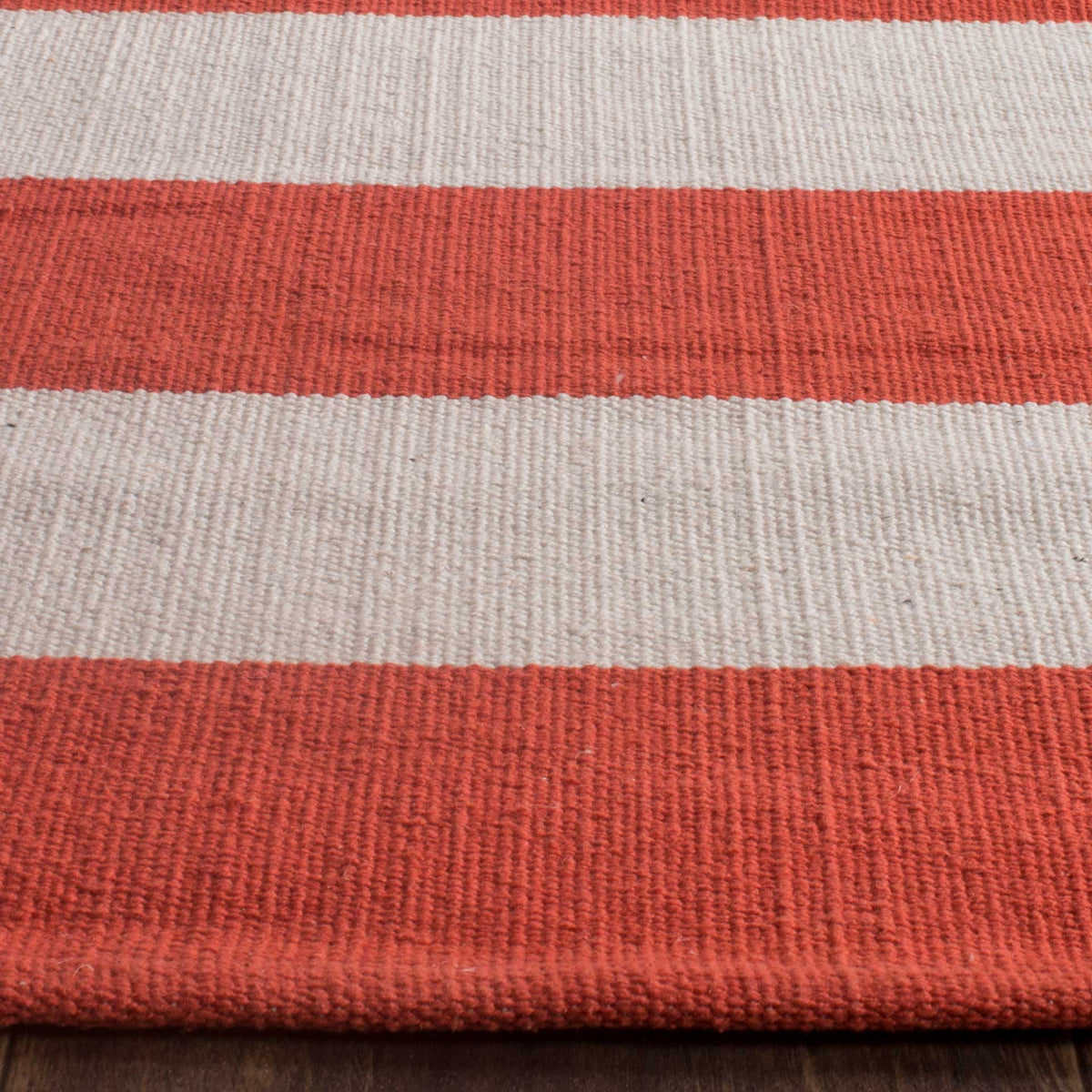 Rust and ivory cotton bands show a rich woven texture and softly finished edge.