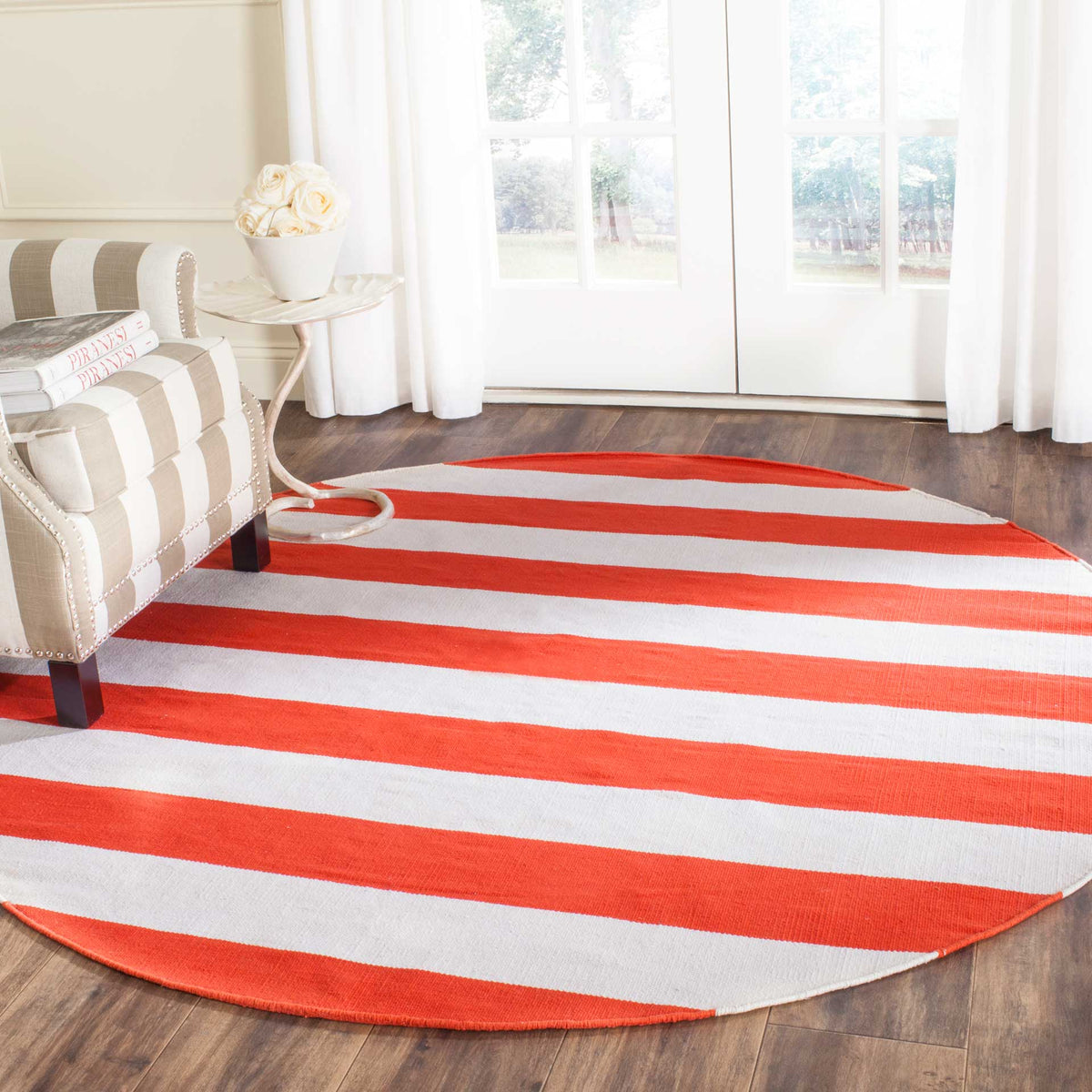Bold rust-orange and ivory stripes bring lively warmth to this round rug in a sunlit living space.