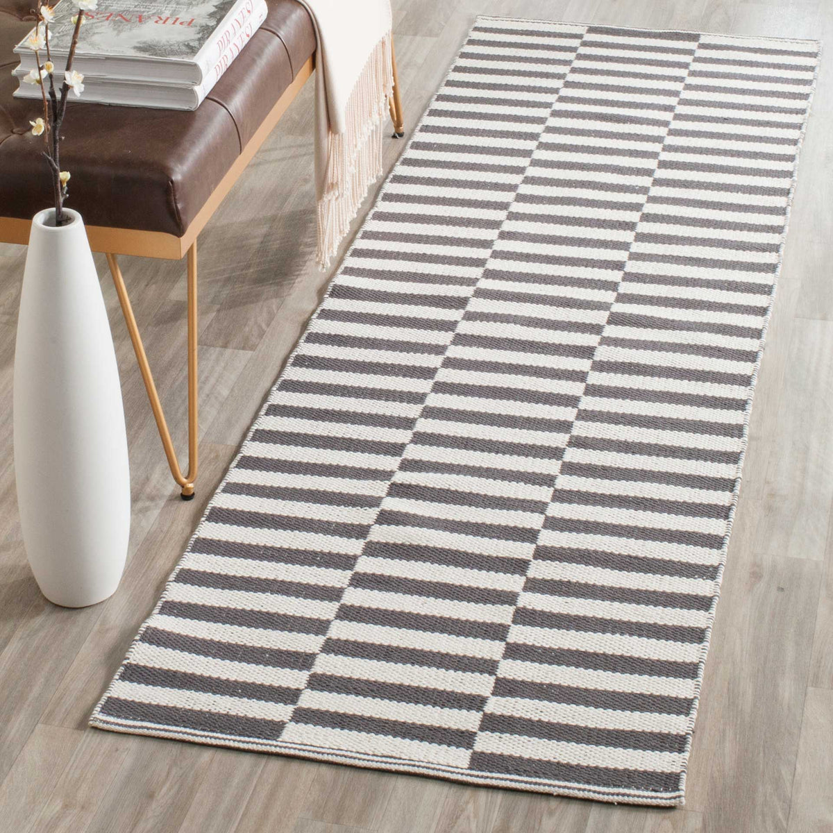 A gray-and-ivory striped runner brings understated pattern to a narrow space