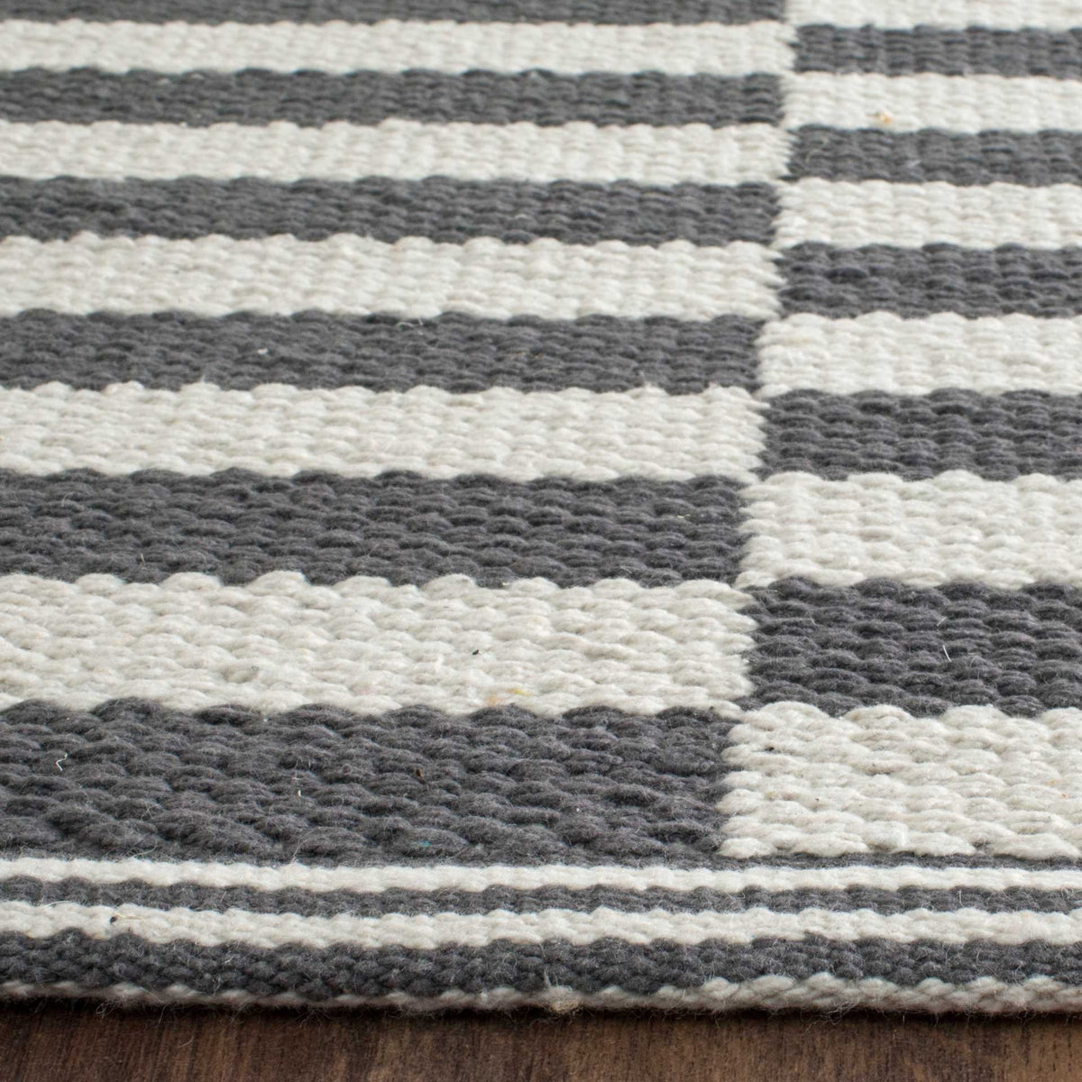 Dense gray and ivory cotton weaving highlights the stripe pattern and tidy finished edge.