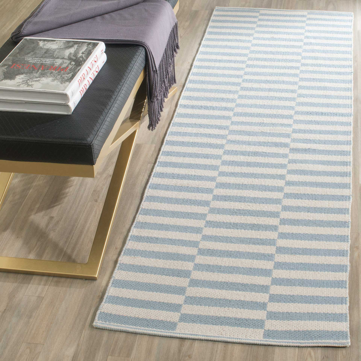 Pale blue stripes soften this ivory runner's clean, repeating design