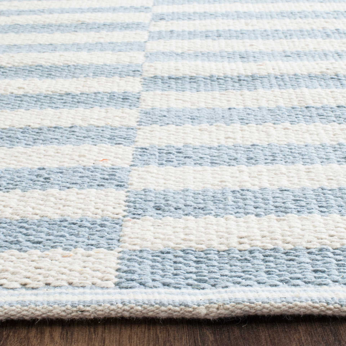 Raised ivory and pale blue cotton stripes lead to a neatly woven border.