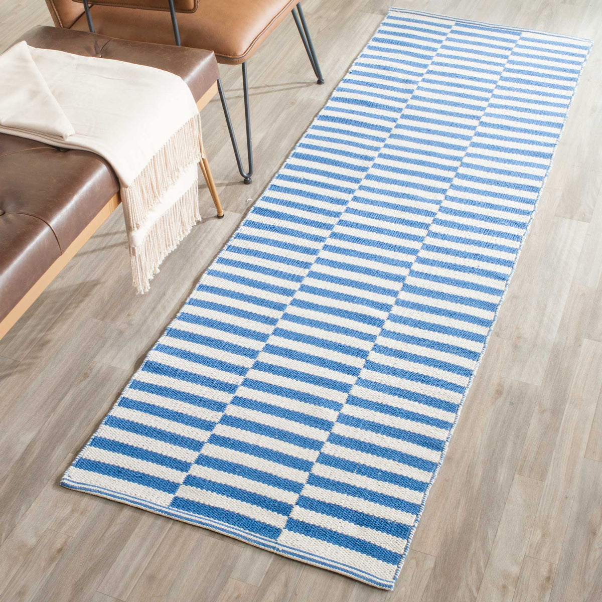 Crisp blue stripes lend fresh color to a long ivory cotton runner