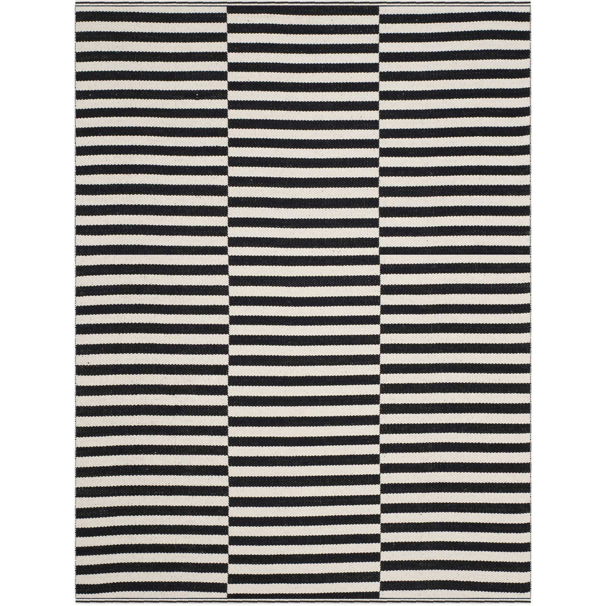Three columns of bold black and ivory stripes add graphic appeal to a compact cotton rug.